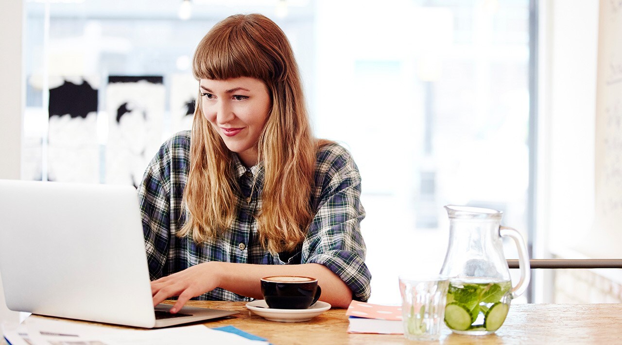 Woman looking at laptop.